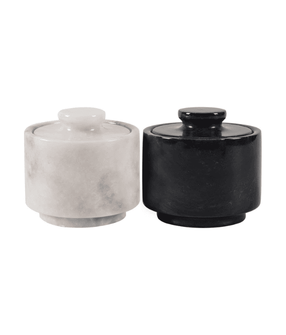 White and black marble cellars with lids.