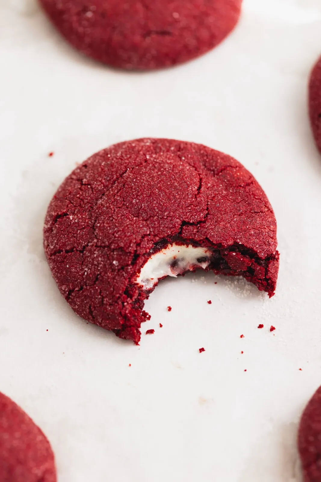 cheesecake stuffed red velvet cookie with a bite taken out