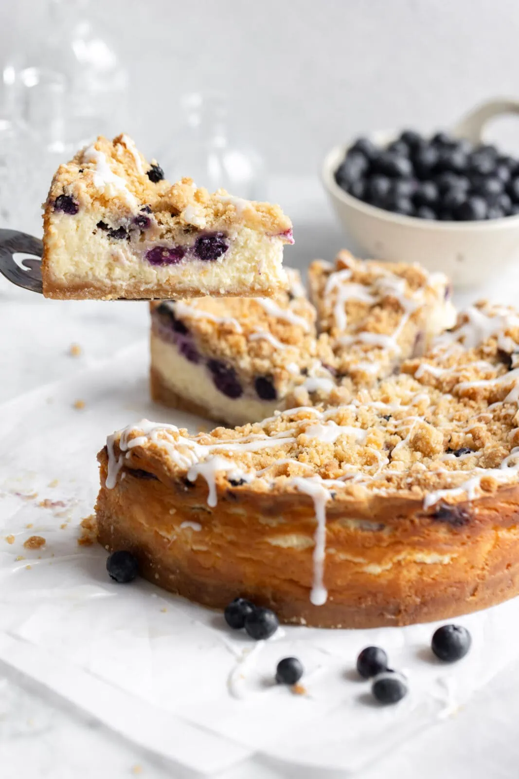 blueberry streusel cheesecake with a sice of cheesecake taken out