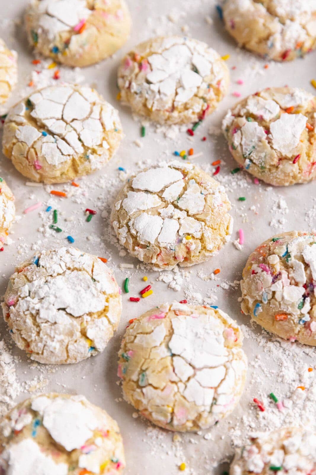 soft and chewy funfetti crinkle cookies coated in powdered sugar