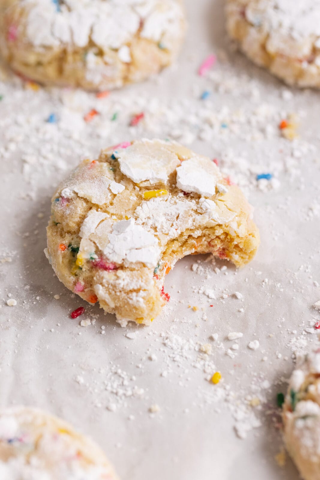 funfetti crinkle cookie with a bite taken out