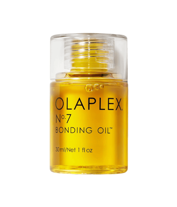Small clear container with yellow hair oil.
