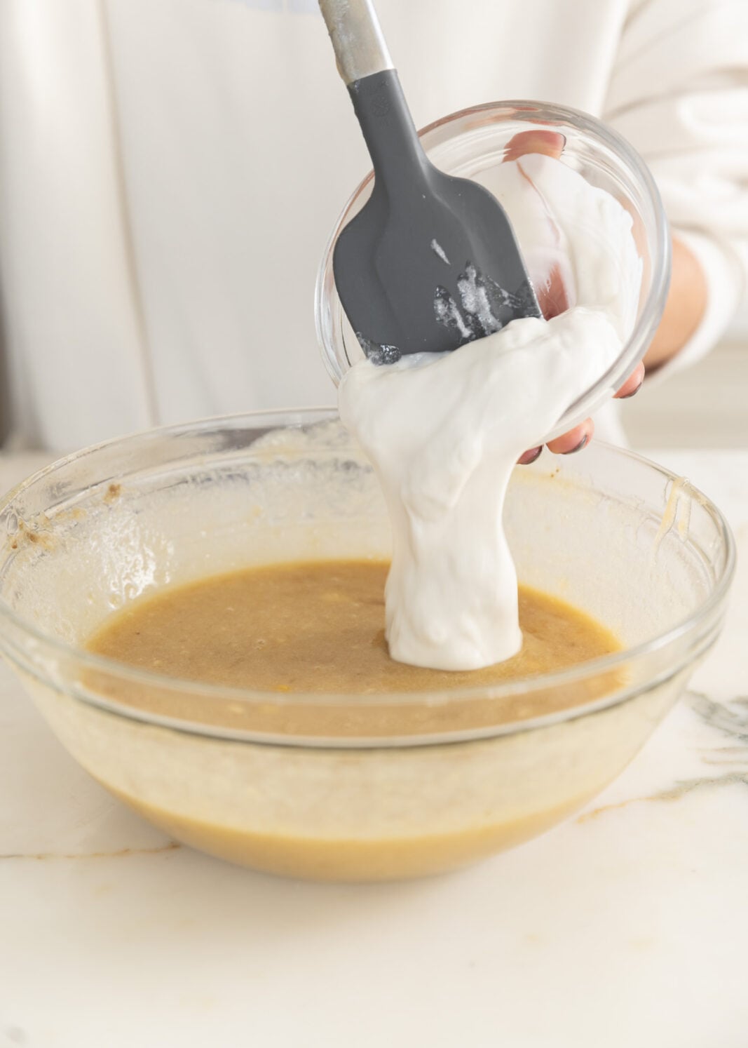 greek yogurt going into bowl
