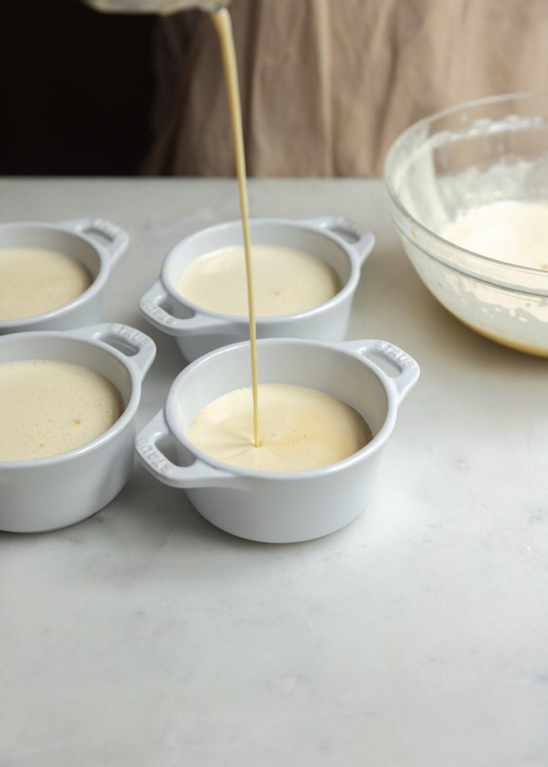 divide the custard between the ramekins