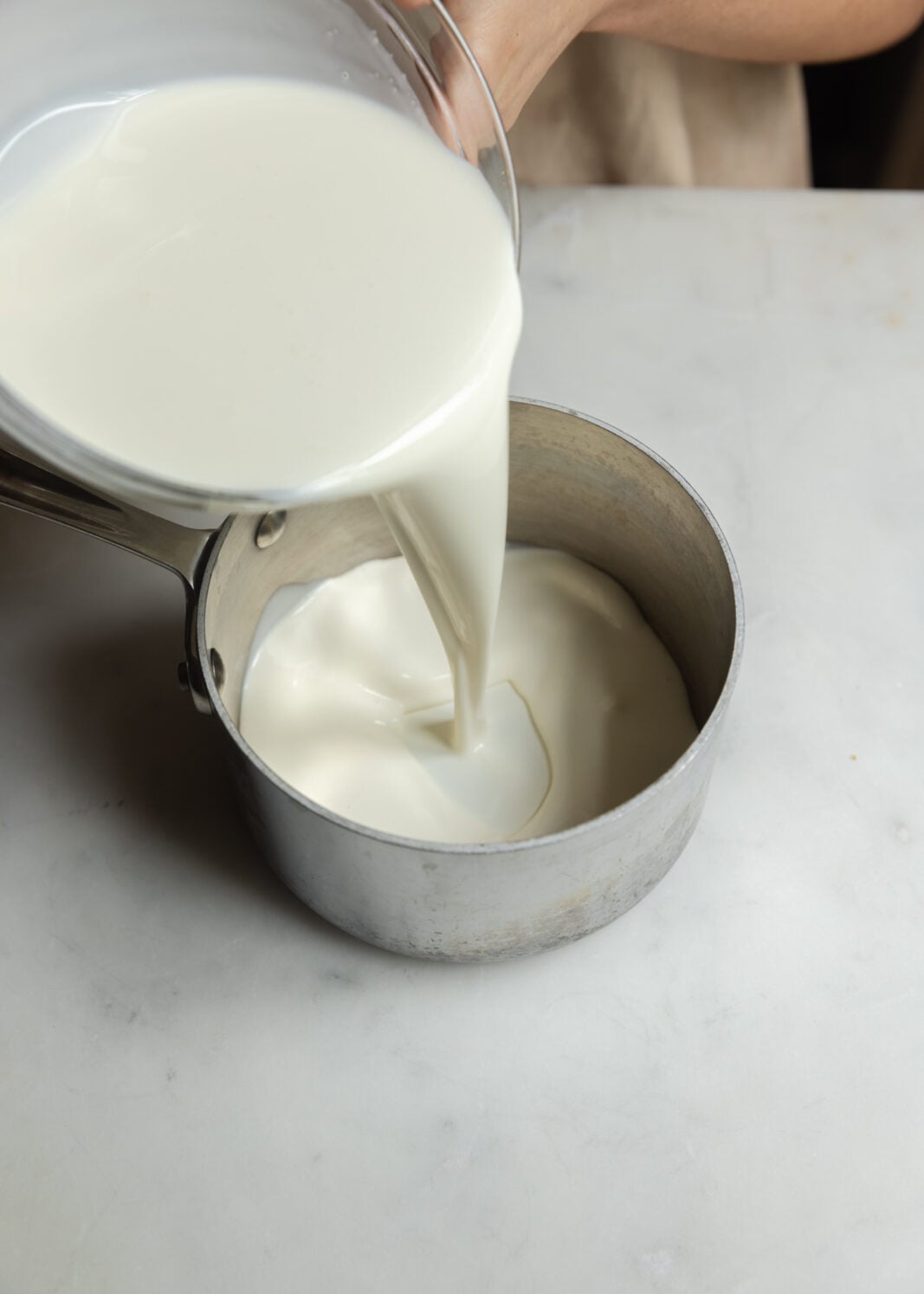 warm heavy cream in a saucepan